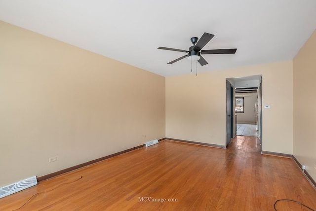 empty room with visible vents, ceiling fan, light wood-style flooring, and baseboards