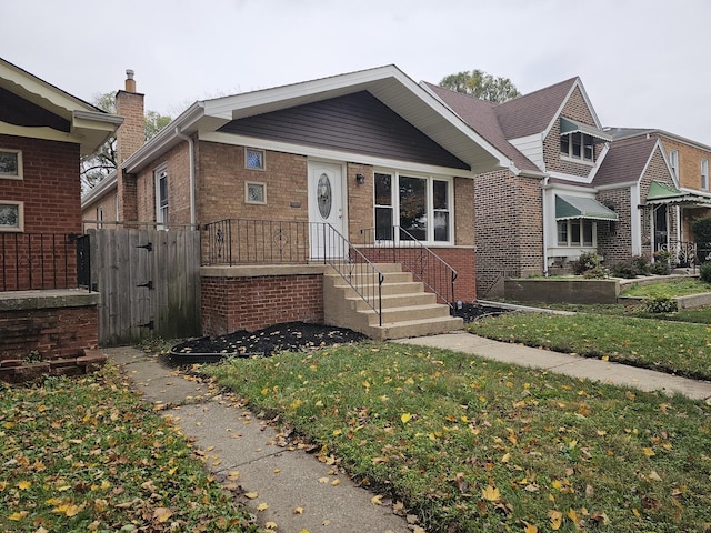 view of front of house with brick siding and a front yard