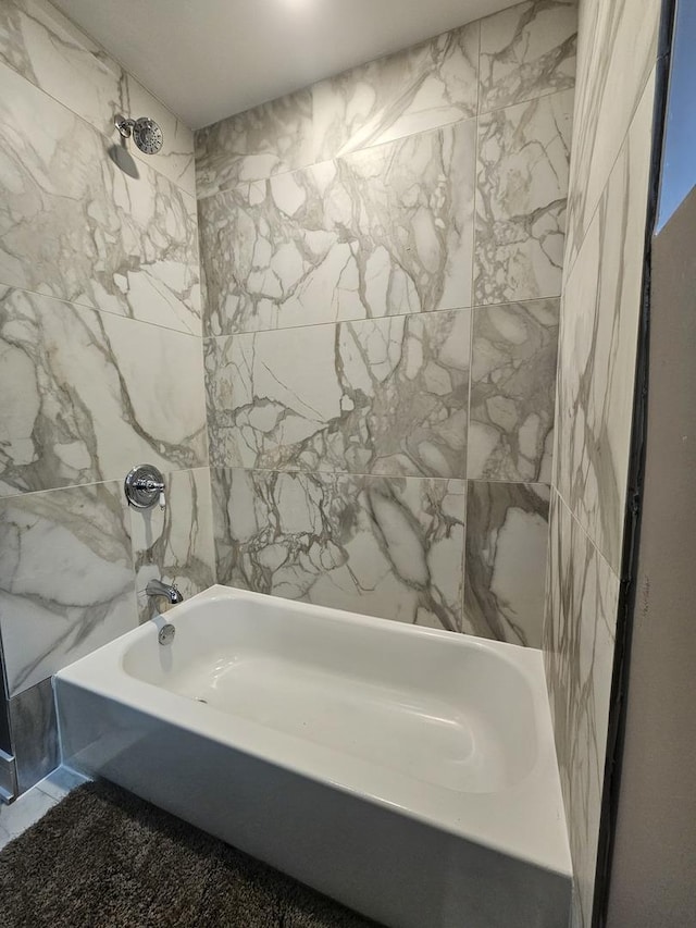 full bath with tile walls and shower / bathing tub combination