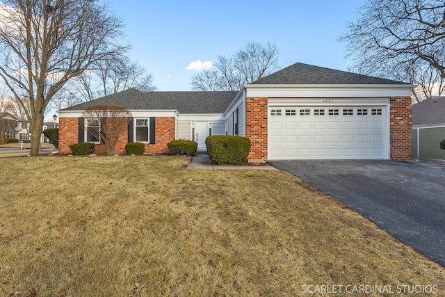 ranch-style house with a garage, aphalt driveway, a front yard, and brick siding