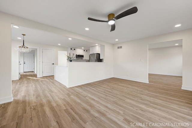 unfurnished living room featuring recessed lighting, visible vents, ceiling fan, light wood-type flooring, and baseboards