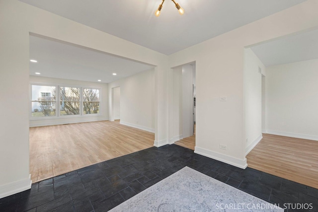 unfurnished room featuring recessed lighting, baseboards, and wood finished floors