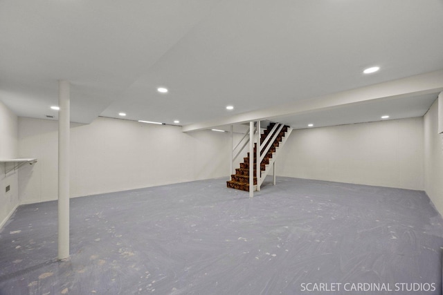 finished basement featuring stairway and recessed lighting