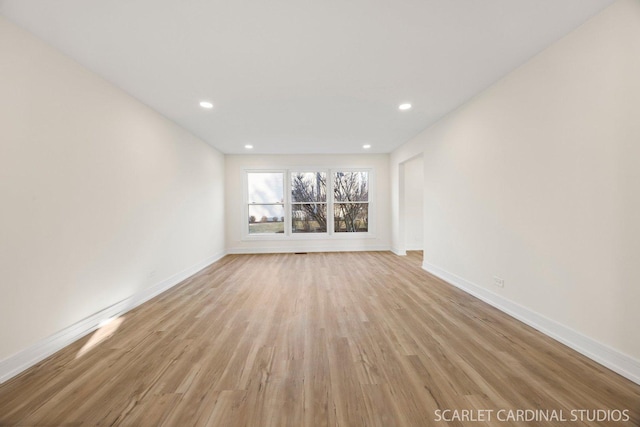 spare room with light wood-style floors, baseboards, and recessed lighting