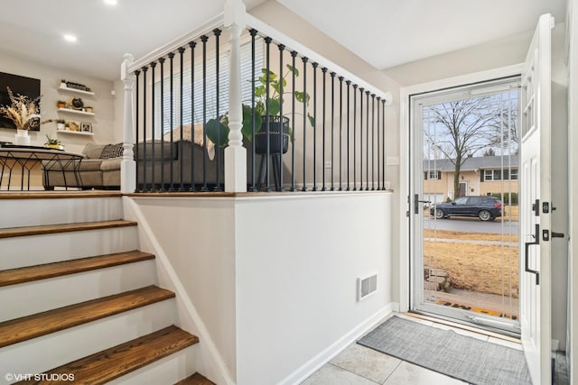 stairway featuring recessed lighting, visible vents, and tile patterned floors