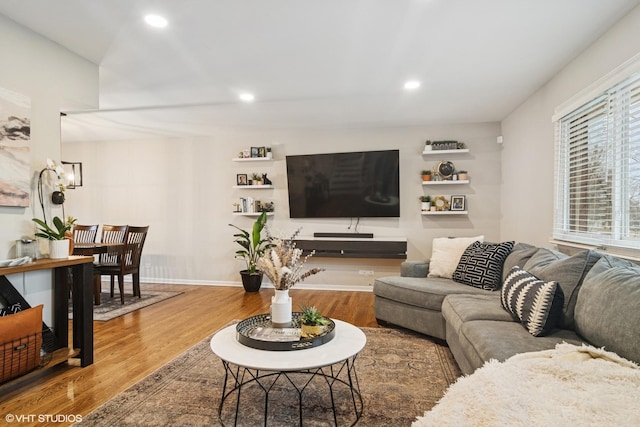 living area featuring baseboards, a chandelier, wood finished floors, and recessed lighting