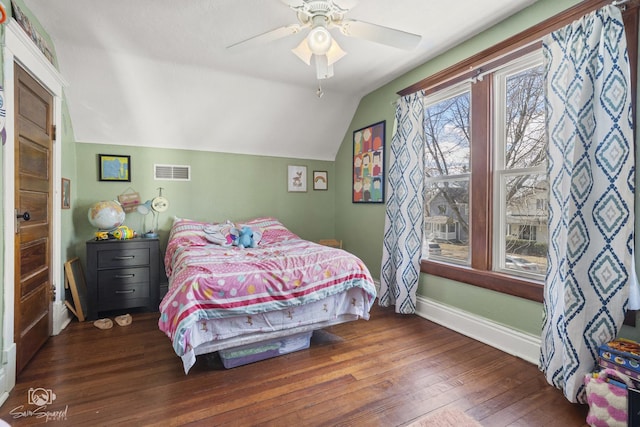 bedroom with lofted ceiling, visible vents, hardwood / wood-style floors, a ceiling fan, and baseboards