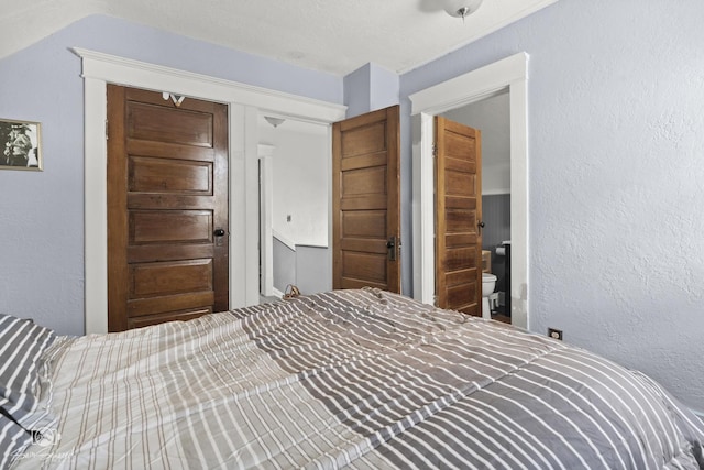 bedroom featuring a textured wall