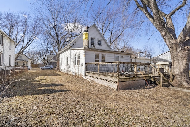 exterior space featuring a chimney and a deck