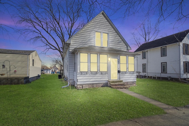 view of front of home featuring entry steps and a yard