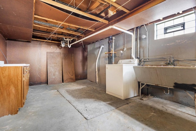 basement featuring washer / dryer and a sink