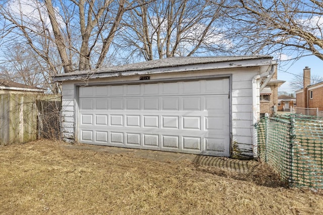 detached garage featuring fence