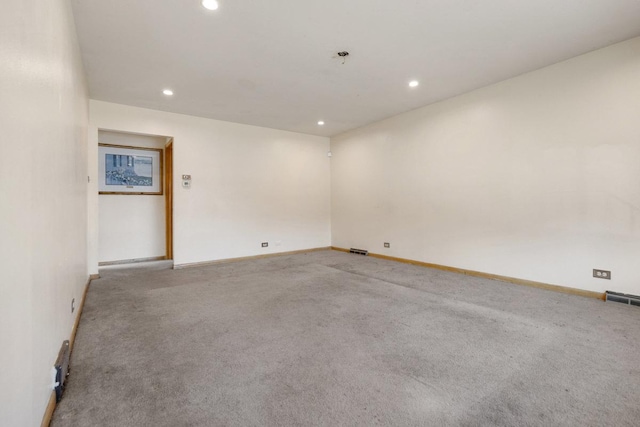 unfurnished room featuring baseboards, carpet floors, visible vents, and recessed lighting