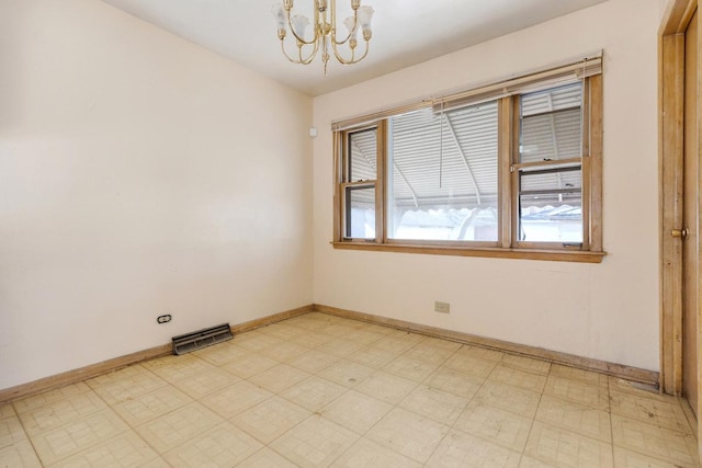 empty room featuring baseboards, a notable chandelier, visible vents, and light floors