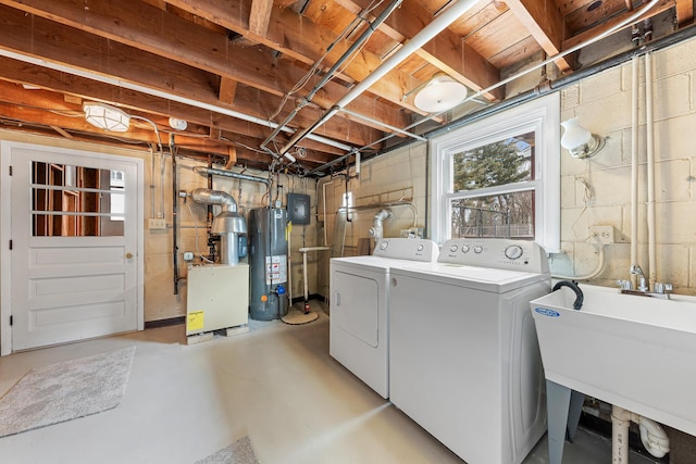 laundry room featuring water heater, laundry area, a sink, and washing machine and dryer