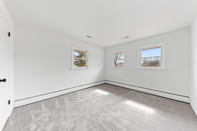 carpeted spare room featuring visible vents