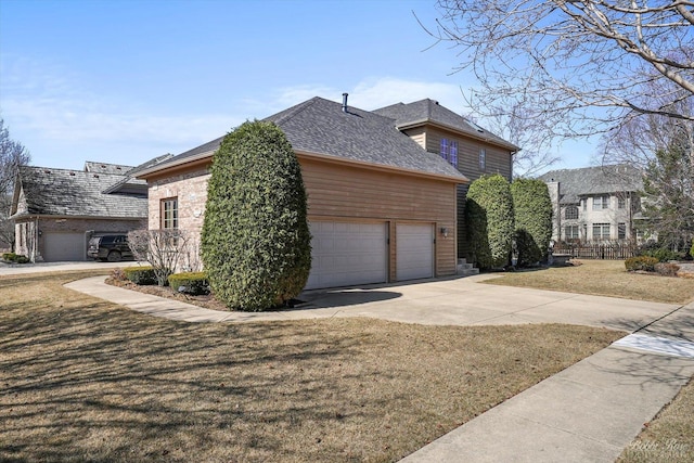 view of side of home featuring concrete driveway, an attached garage, and a lawn