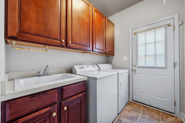 laundry room featuring a sink, cabinet space, and separate washer and dryer