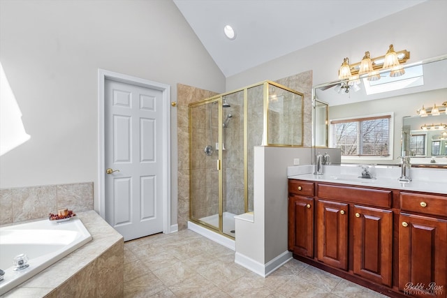 full bathroom featuring a stall shower, vanity, a garden tub, and vaulted ceiling