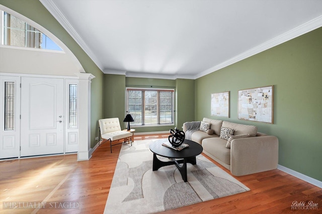 living room with light wood-style flooring, baseboards, and ornamental molding