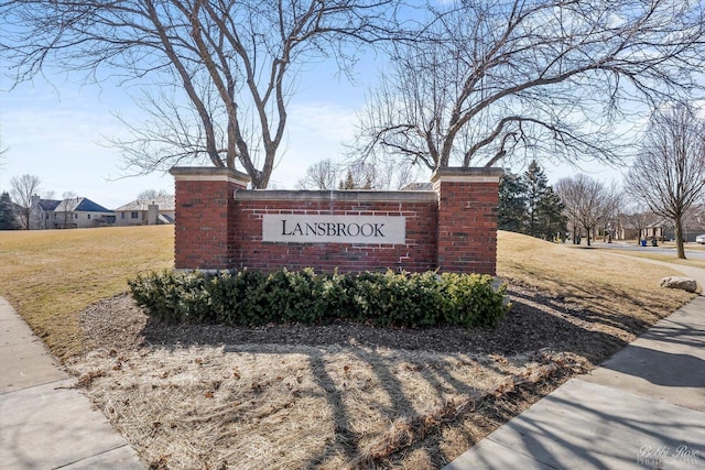 community sign featuring a yard