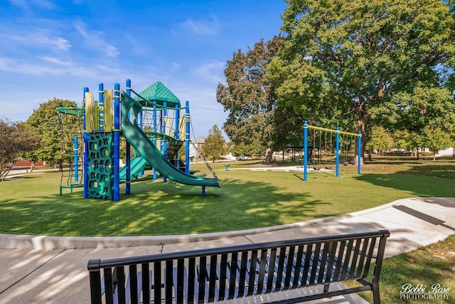 community jungle gym with a lawn