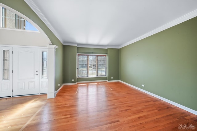 entryway featuring light wood-style floors, baseboards, and ornamental molding