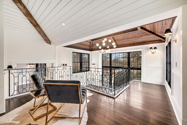 hall featuring wood ceiling, lofted ceiling with beams, an upstairs landing, an inviting chandelier, and wood finished floors