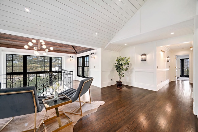 interior space featuring an inviting chandelier, wooden ceiling, lofted ceiling, and wood finished floors