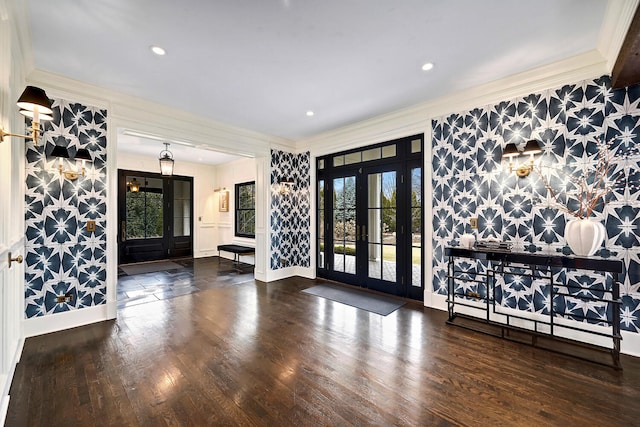 foyer with french doors, a healthy amount of sunlight, and ornamental molding