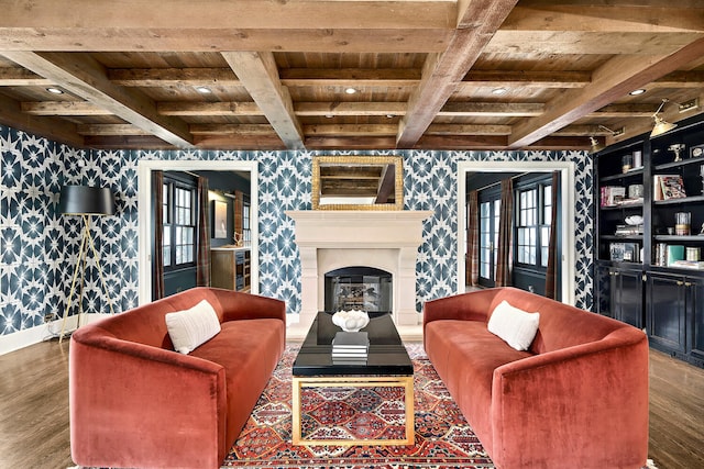 living area with wallpapered walls, wooden ceiling, wood finished floors, and a glass covered fireplace