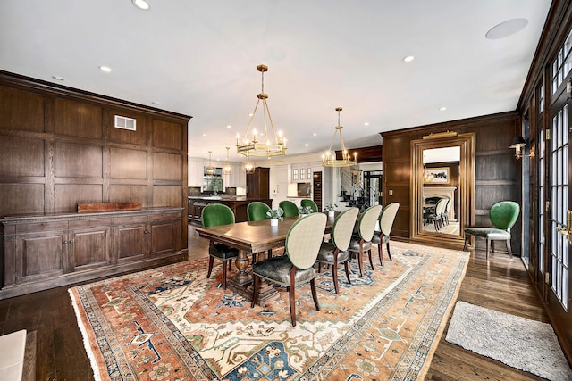 dining room with visible vents, recessed lighting, dark wood-type flooring, crown molding, and a chandelier