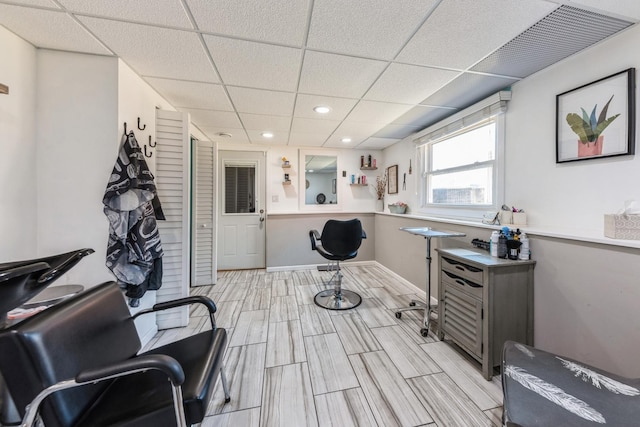 misc room with wood finish floors, a drop ceiling, baseboards, and recessed lighting