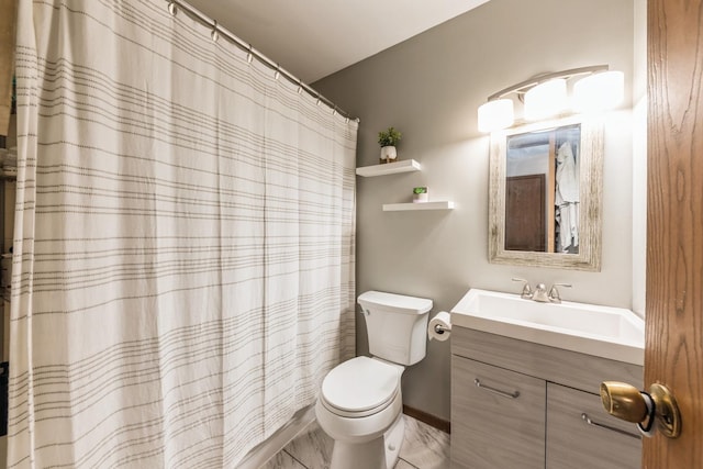 bathroom featuring vanity, curtained shower, and toilet