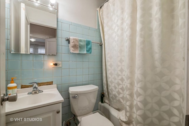 full bathroom with vanity, tile walls, toilet, and shower / tub combo with curtain