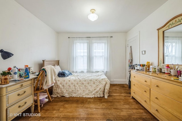 bedroom with dark wood finished floors