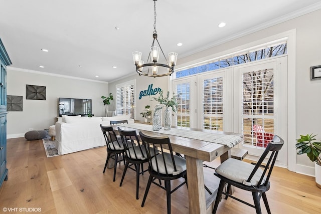 dining space featuring light wood finished floors, ornamental molding, and recessed lighting