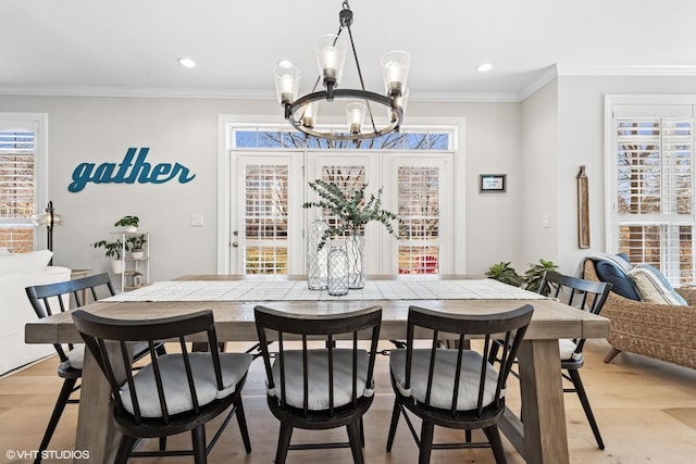 dining room featuring a chandelier, light wood-type flooring, crown molding, and recessed lighting