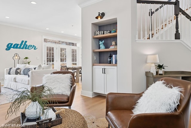 living room featuring ornamental molding, recessed lighting, light wood-style flooring, and stairs