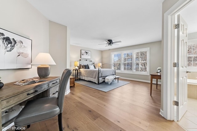 bedroom with ceiling fan, light wood-style flooring, and baseboards