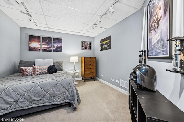 bedroom with rail lighting, baseboards, visible vents, and light colored carpet