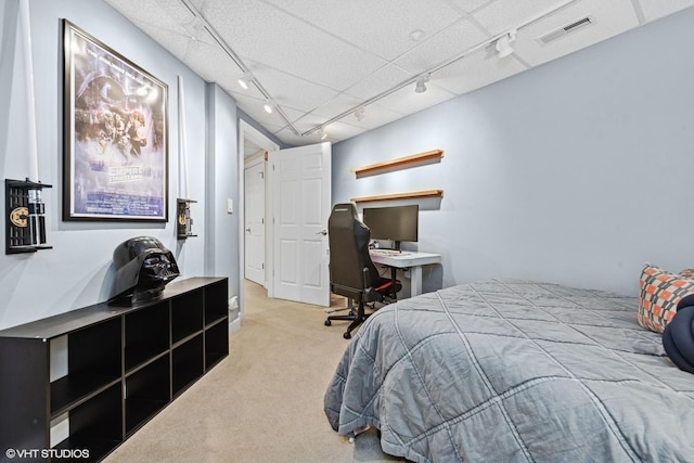 bedroom with carpet, rail lighting, and visible vents