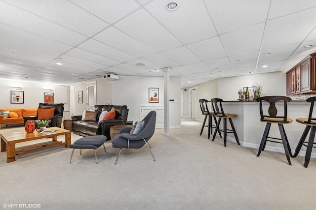 living room featuring a dry bar, baseboards, light colored carpet, a paneled ceiling, and recessed lighting