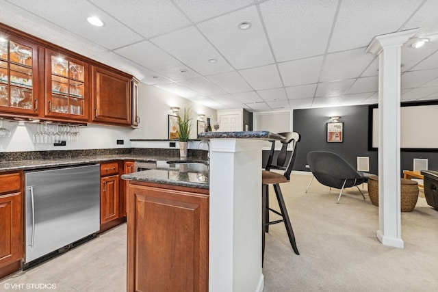 bar with light colored carpet, dishwashing machine, bar, a paneled ceiling, and a sink