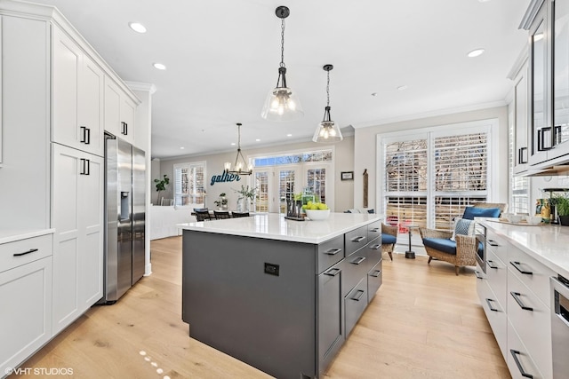 kitchen featuring gray cabinets, white cabinets, crown molding, and stainless steel refrigerator with ice dispenser