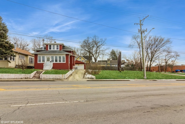 view of front of home featuring fence