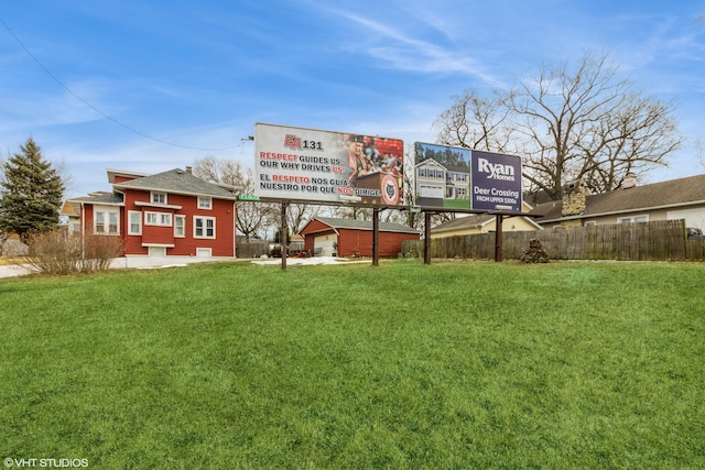 rear view of property with a lawn and fence