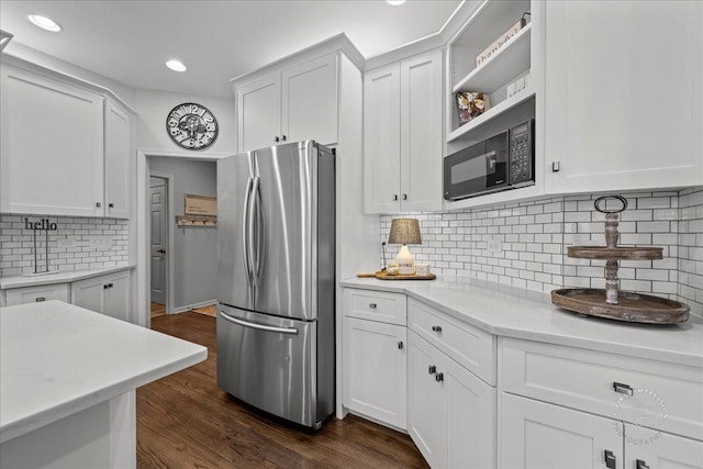 kitchen with decorative backsplash, dark wood-type flooring, freestanding refrigerator, white cabinetry, and open shelves