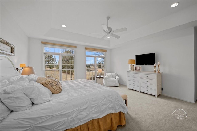 bedroom with a ceiling fan, a tray ceiling, carpet flooring, and recessed lighting