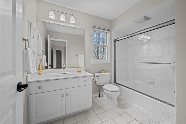 bathroom with toilet, bath / shower combo with glass door, visible vents, vanity, and tile patterned floors